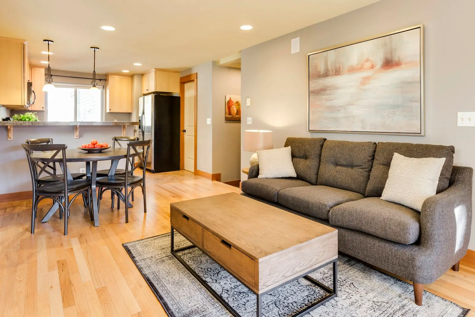 A neat living room with a grey sofa and wooden coffee table